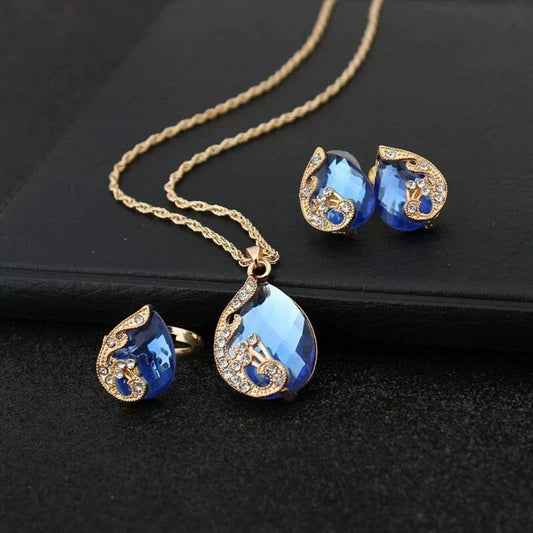 Ensemble collier + boucles d'oreilles pendantes en cristal bleu et or