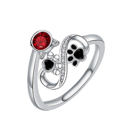 Bague ajustable avec empreinte de patte noire et pierre précieuse rouge