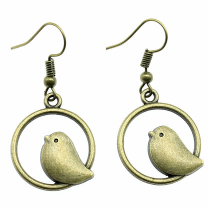 Boucles d'oreilles pendantes vintage avec pendentif oiseau – Bijoux bohèmes faits main